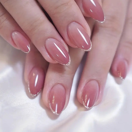 Nude Almond Nails with Glitter-Tipped Elegance