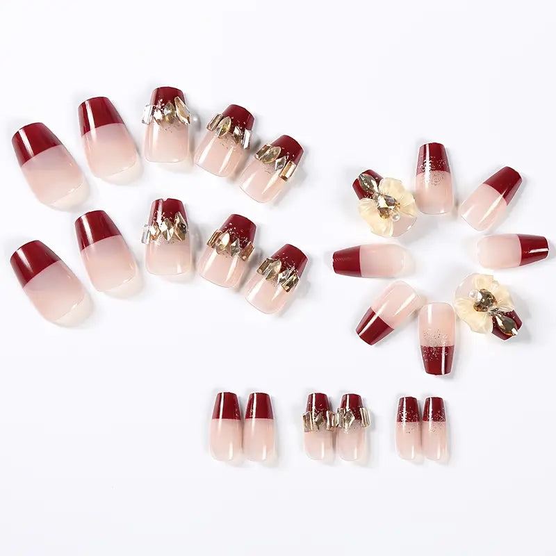 Elegant Red and Nude Gradient Press-On Nails with Gold Embellishments